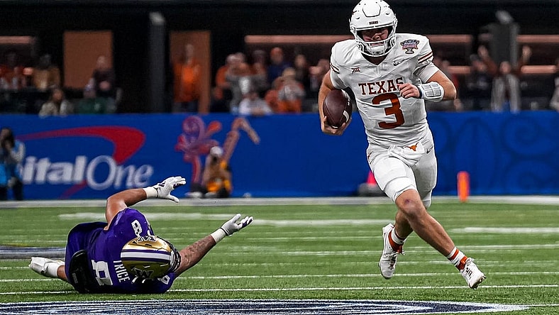 Texas Longhorns quarterback Quinn Ewers (3) evades a tackle by Washington edge Bralen Trice (8) during the Sugar Bowl College Football Playoff  semifinals game at the Caesars Superdome on Monday, Jan. 1, 2024 in New Orleans, Louisiana.