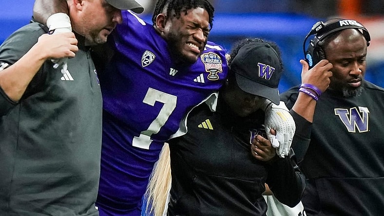 Washington running back Dillon Johnson is helped off the field after an injury during the Huskies' final possession of a 37-31 win against Texas in the Sugar Bowl. Wednesday UW coach Kalen DeBoer said Johnson expects to play in the national championship against Michigan.