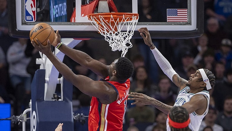 Jan 3, 2024; Minneapolis, Minnesota, USA; New Orleans Pelicans forward Zion Williamson (1) drives to the basket and shoots the ball past Minnesota Timberwolves guard Nickeil Alexander-Walker (9) in the first half at Target Center. Mandatory Credit: Jesse Johnson-USA TODAY Sports