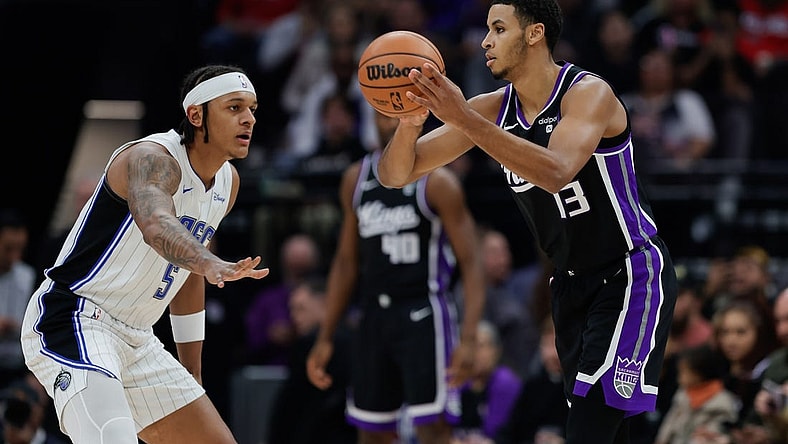 Jan 3, 2024; Sacramento, California, USA; Sacramento Kings forward Keegan Murray (13) looks to pass the ball against Orlando Magic forward Paolo Banchero (5) during the first quarter at Golden 1 Center. Mandatory Credit: Sergio Estrada-USA TODAY Sports