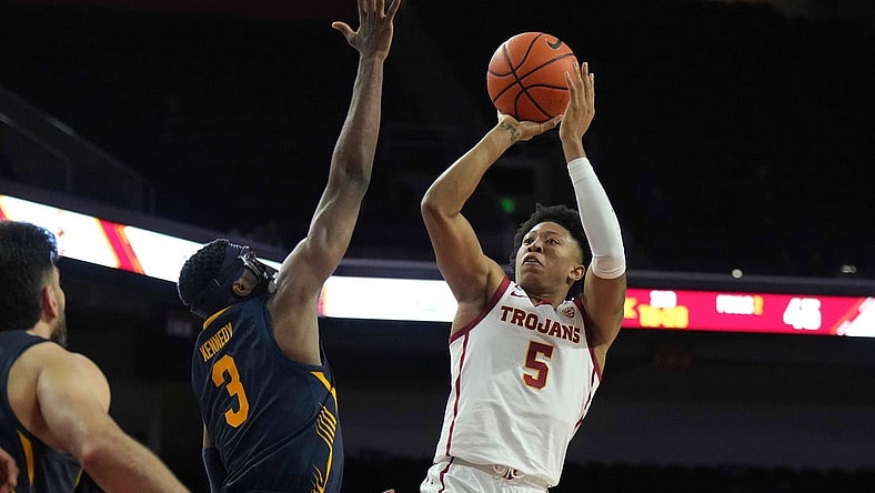Jan 3, 2024; Los Angeles, California, USA; Southern California Trojans guard Boogie Ellis (5) shoots the ball against California Golden Bears guard Keonte Kennedy (3) in the second half at Galen Center. Mandatory Credit: Kirby Lee-USA TODAY Sports