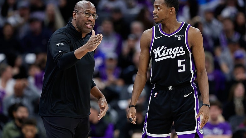 Jan 3, 2024; Sacramento, California, USA; Sacramento Kings head coach Mike Brown talks with guard De'Aaron Fox (5) during the third quarter against the Orlando Magic at Golden 1 Center. Mandatory Credit: Sergio Estrada-USA TODAY Sports