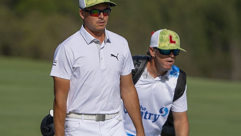 January 4, 2024; Maui, Hawaii, USA; Rickie Fowler (left) and caddie caddie Ricky Romano (right) walk on the fourth hole during the first round of The Sentry Tournament of Champions golf tournament at Kapalua Golf - The Plantation Course. Mandatory Credit: Kyle Terada-USA TODAY Sports