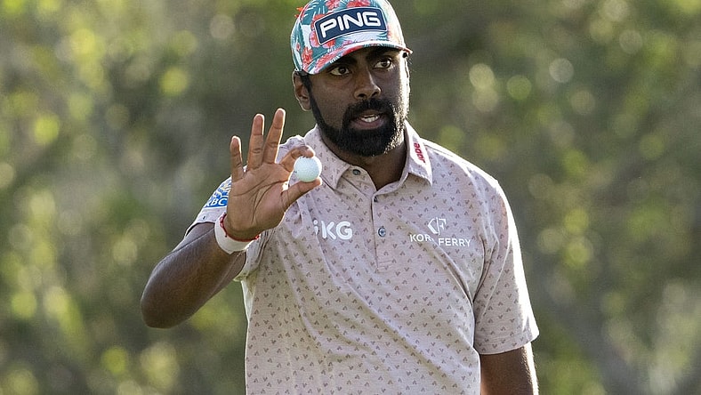 January 4, 2024; Maui, Hawaii, USA; Sahith Theegala acknowledges the crowd after making his putt on the 18th hole during the first round of The Sentry golf tournament at Kapalua Golf - The Plantation Course. Mandatory Credit: Kyle Terada-USA TODAY Sports