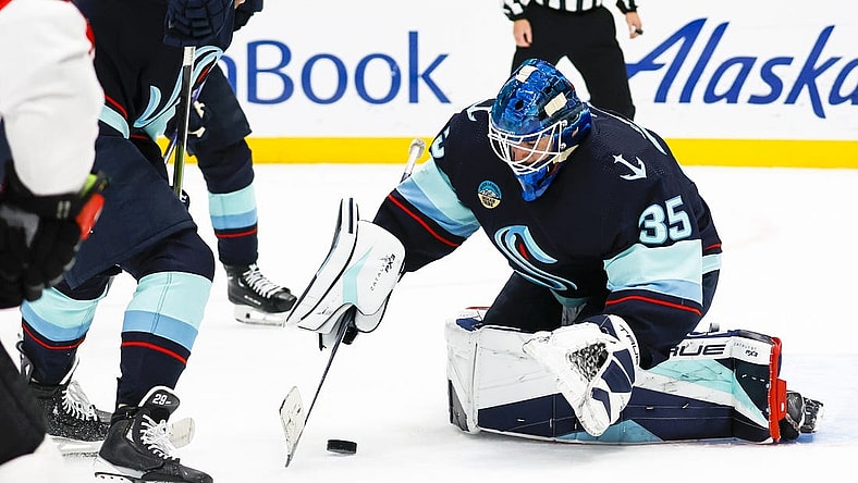 Jan 4, 2024; Seattle, Washington, USA; Seattle Kraken goaltender Joey Daccord (35) collects the puck during the first period against the Ottawa Senators at Climate Pledge Arena. Mandatory Credit: Joe Nicholson-USA TODAY Sports