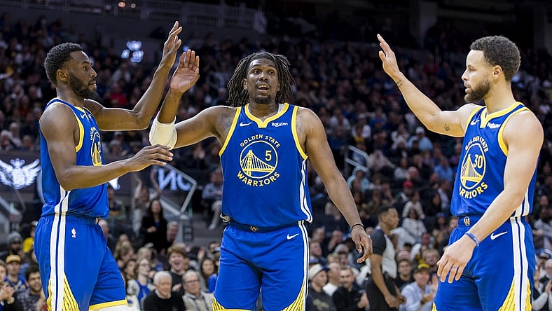 Jan 4, 2024; San Francisco, California, USA; Golden State Warriors forward Andrew Wiggins (22) and guard Kevon Looney (5) and guard Stephen Curry (30) react after drawing a foul against the Denver Nuggets during the first half at Chase Center. Mandatory Credit: John Hefti-USA TODAY Sports