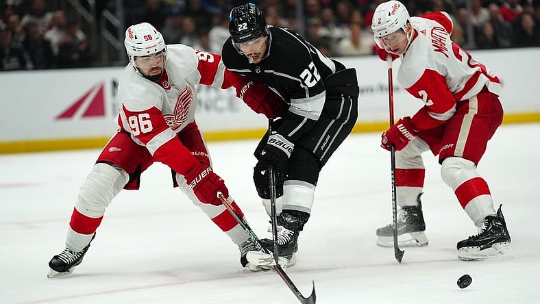 Jan 4, 2024; Los Angeles, California, USA; Detroit Red Wings defenseman Jake Walman (96) and defenseman Olli Maatta (2) battle for the puck with LA Kings left wing Kevin Fiala (22) in the second period at Crypto.com Arena. Mandatory Credit: Kirby Lee-USA TODAY Sports