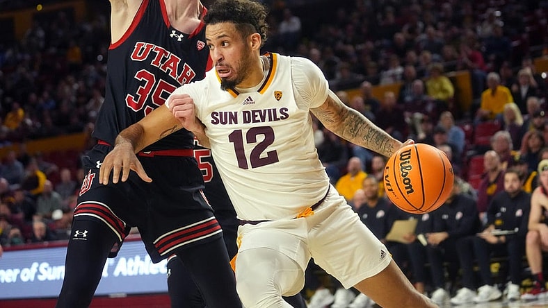 Jan 4, 2024; Tempe, Arizona, USA; ASU Sun Devils guard Jose Perez (12) drives past Utah Utes center Branden Carlson (35) at Desert Financial Arena.
