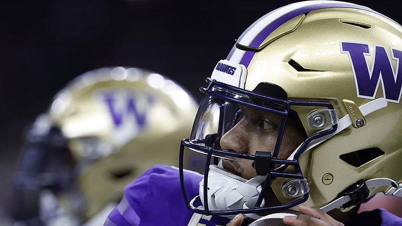 Jan 1, 2024; New Orleans, LA, USA; Washington Huskies quarterback Michael Penix Jr. (9) warms up during a timeout against the Texas Longhorns in the 2024 Sugar Bowl college football playoff semifinal game at Caesars Superdome. Mandatory Credit: Geoff Burke-USA TODAY Sports