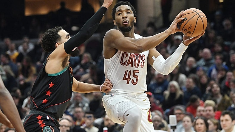 Jan 5, 2024; Cleveland, Ohio, USA; Cleveland Cavaliers guard Donovan Mitchell (45) drives to the basket against Washington Wizards guard Tyus Jones (5) during the first half at Rocket Mortgage FieldHouse. Mandatory Credit: Ken Blaze-USA TODAY Sports