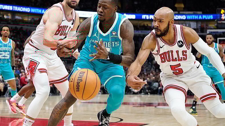 Jan 5, 2024; Chicago, Illinois, USA; Chicago Bulls guard Zach LaVine (8) and guard Jevon Carter (5) defend Charlotte Hornets guard Terry Rozier (3) during the first quarter at United Center. Mandatory Credit: David Banks-USA TODAY Sports
