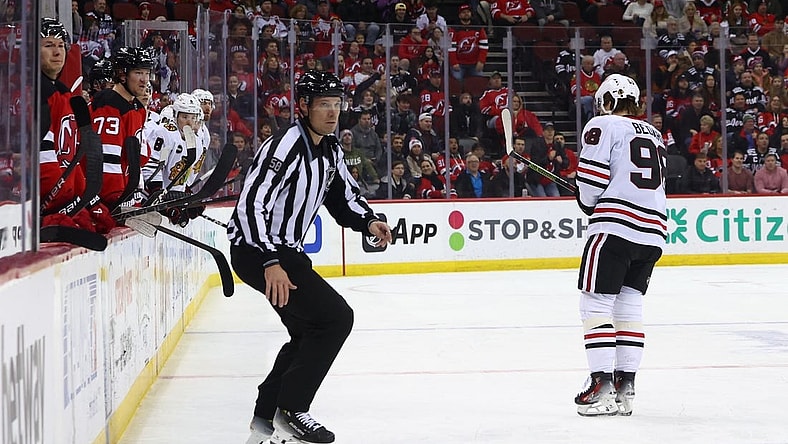 Jan 5, 2024; Newark, New Jersey, USA; Chicago Blackhawks center Connor Bedard (98) leaves the ice after being hit by New Jersey Devils defenseman Brendan Smith (2) (not shown) during the first period at Prudential Center. Mandatory Credit: Ed Mulholland-USA TODAY Sports