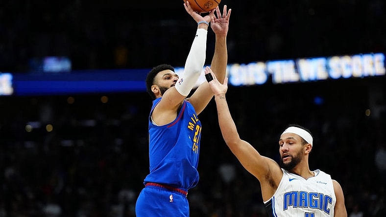 Jan 5, 2024; Denver, Colorado, USA; Denver Nuggets guard Jamal Murray (27) shoots over Orlando Magic guard Jalen Suggs (4) in the first quarter at Ball Arena. Mandatory Credit: Ron Chenoy-USA TODAY Sports