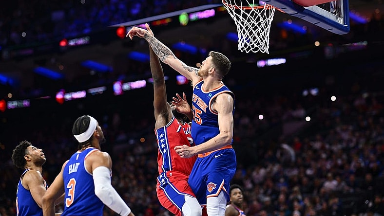 Jan 5, 2024; Philadelphia, Pennsylvania, USA; New York Knicks center Isaiah Hartenstein (55) blocks a shot from Philadelphia 76ers center Joel Embiid (21) in the fourth quarter at Wells Fargo Center. Mandatory Credit: Kyle Ross-USA TODAY Sports