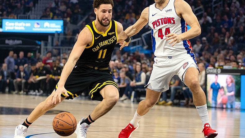 Jan 5, 2024; San Francisco, California, USA; Golden State Warriors guard Klay Thompson (11) drives past Detroit Pistons forward Bojan Bogdanovic (44) during the first quarter at Chase Center. Mandatory Credit: D. Ross Cameron-USA TODAY Sports