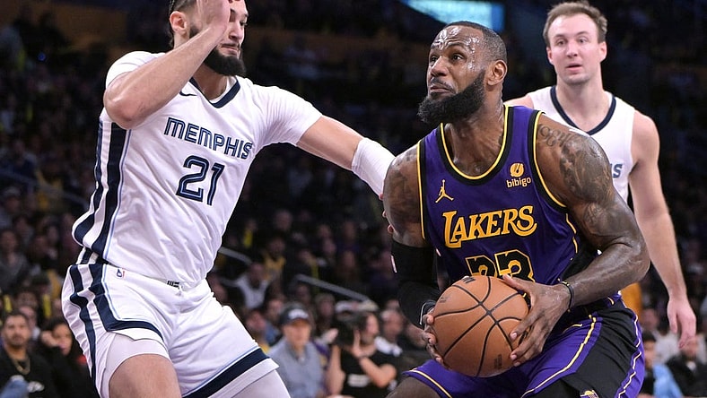 Jan 5, 2024; Los Angeles, California, USA; Los Angeles Lakers forward LeBron James (23) drives to the basket past Memphis Grizzlies forward David Roddy (21) in the first half at Crypto.com Arena. Mandatory Credit: Jayne Kamin-Oncea-USA TODAY Sports