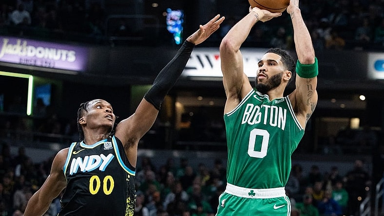 Jan 6, 2024; Indianapolis, Indiana, USA; Boston Celtics forward Jayson Tatum (0) shoots the ball against Indiana Pacers guard Bennedict Mathurin (00) in the first half at Gainbridge Fieldhouse. Mandatory Credit: Trevor Ruszkowski-USA TODAY Sports