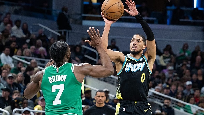 Jan 6, 2024; Indianapolis, Indiana, USA; Indiana Pacers guard Tyrese Haliburton (0) shoots the ball against Boston Celtics guard Jaylen Brown (7) in the second half at Gainbridge Fieldhouse. Mandatory Credit: Trevor Ruszkowski-USA TODAY Sports