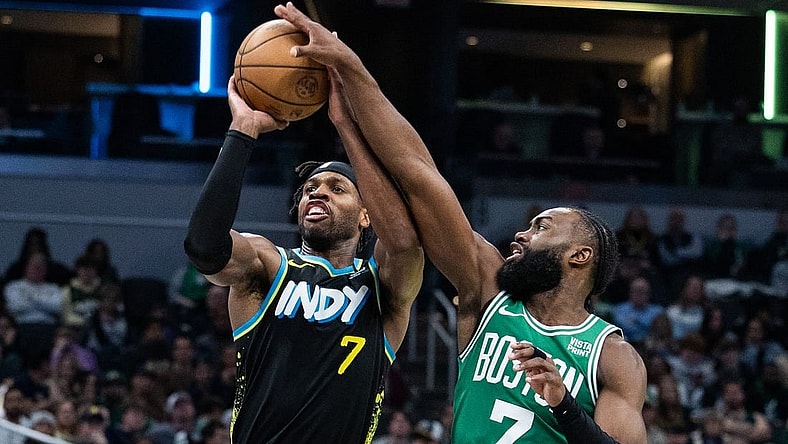 Jan 6, 2024; Indianapolis, Indiana, USA; Boston Celtics guard Jaylen Brown (7) blocks a shot by Indiana Pacers guard Buddy Hield (7) in the second half at Gainbridge Fieldhouse. Mandatory Credit: Trevor Ruszkowski-USA TODAY Sports