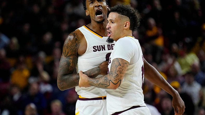 Jan. 6, 2024; Phoenix, Ariz; USA; ASU guard Jose Perez (12) holds back center Shawn Phillips Jr. (9) from arguing with an official during a game against Colorado at Desert Financial Arena.