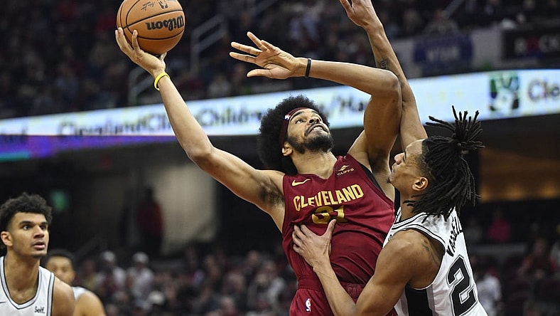 Jan 7, 2024; Cleveland, Ohio, USA; Cleveland Cavaliers center Jarrett Allen (31) shoots beside San Antonio Spurs guard Devin Vassell (24) in the second quarter at Rocket Mortgage FieldHouse. Mandatory Credit: David Richard-USA TODAY Sports