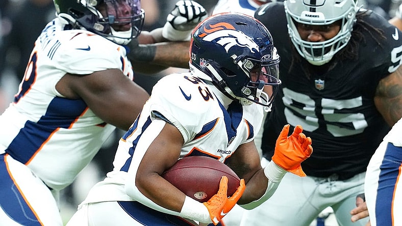 Jan 7, 2024; Paradise, Nevada, USA; Denver Broncos running back Javonte Williams (33) carries against the Las Vegas Raiders during the first quarter at Allegiant Stadium. Mandatory Credit: Stephen R. Sylvanie-USA TODAY Sports