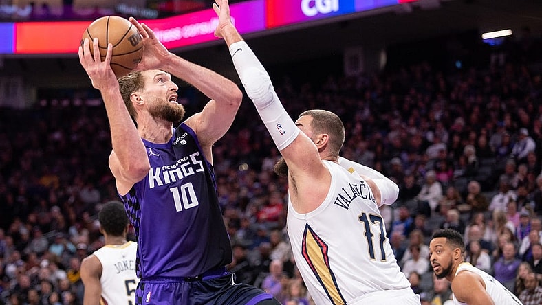 Jan 7, 2024; Sacramento, California, USA; Sacramento Kings forward Domantas Sabonis (10) controls the ball against New Orleans Pelicans center Jonas Valanciunas (17) during the first quarter at Golden 1 Center. Mandatory Credit: Ed Szczepanski-USA TODAY Sports