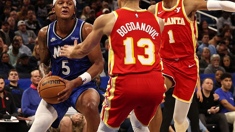 Jan 7, 2024; Orlando, Florida, USA; Orlando Magic forward Paolo Banchero (5) drives to the basket as Atlanta Hawks guard Bogdan Bogdanovic (13) defends during the second half at Kia Center. Mandatory Credit: Kim Klement Neitzel-USA TODAY Sports
