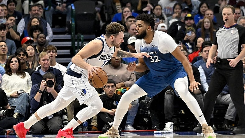 Jan 7, 2024; Dallas, Texas, USA; Dallas Mavericks guard Luka Doncic (77) drives to the basket past Minnesota Timberwolves center Karl-Anthony Towns (32) during the second quarter at the American Airlines Center. Mandatory Credit: Jerome Miron-USA TODAY Sports