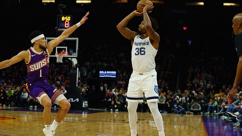 Jan 7, 2024; Phoenix, Arizona, USA;  Memphis Grizzlies guard Marcus Smart (36) squares up against Phoenix Suns guard Devin Booker (1) during the first quarter at Footprint Center. Mandatory Credit: Allan Henry-USA TODAY Sports