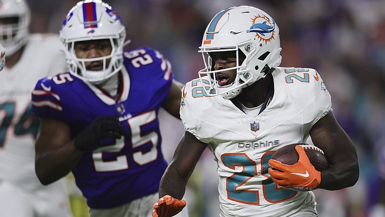 Jan 7, 2024; Miami Gardens, Florida, USA; Miami Dolphins running back De'Von Achane (28) runs with the football against the Buffalo Bills during the first quarter at Hard Rock Stadium. Mandatory Credit: Sam Navarro-USA TODAY Sports