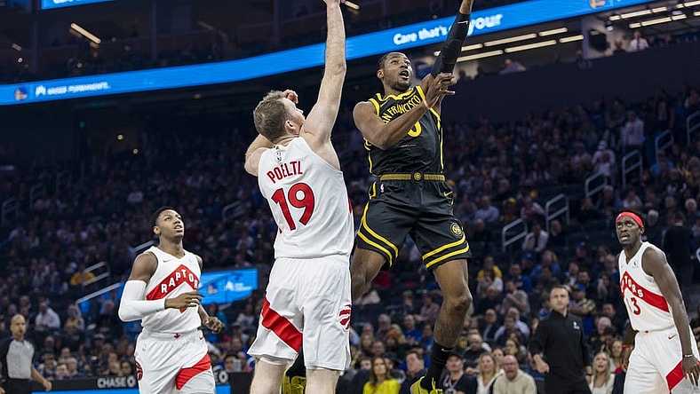 Jan 7, 2024; San Francisco, California, USA;  Toronto Raptors center Jakob Poeltl (19) defends against a shot by Golden State Warriors forward Jonathan Kuminga (00)  during the first half at Chase Center. Mandatory Credit: John Hefti-USA TODAY Sports