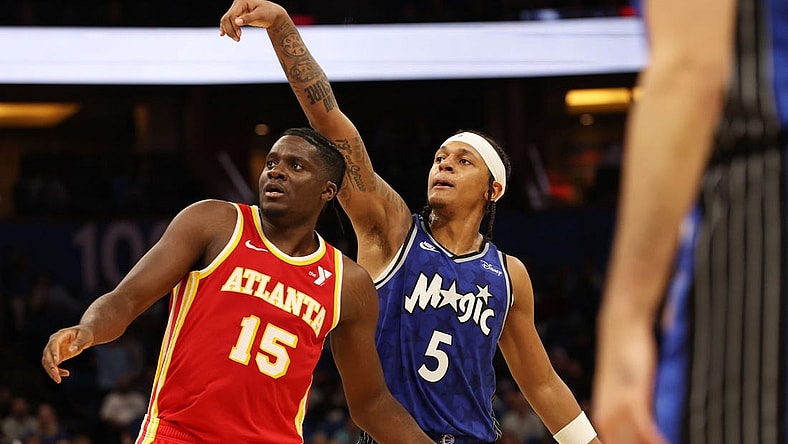 Jan 7, 2024; Orlando, Florida, USA; Orlando Magic forward Paolo Banchero (5) makes a three pointer over Atlanta Hawks center Clint Capela (15) during overtime at Kia Center. Mandatory Credit: Kim Klement Neitzel-USA TODAY Sports