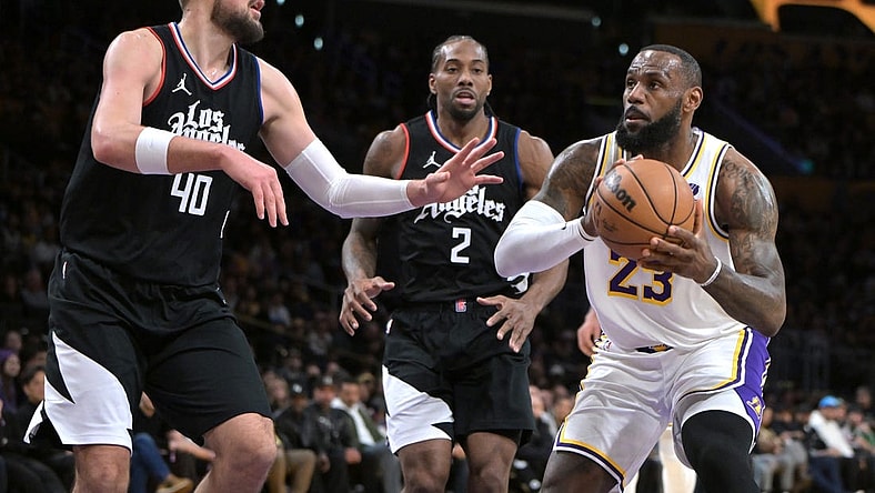 Jan 7, 2024; Los Angeles, California, USA; Los Angeles Lakers forward LeBron James (23) drives past Los Angeles Clippers center Ivica Zubac (40) and forward Kawhi Leonard (2) in the first half at Crypto.com Arena. Mandatory Credit: Jayne Kamin-Oncea-USA TODAY Sports