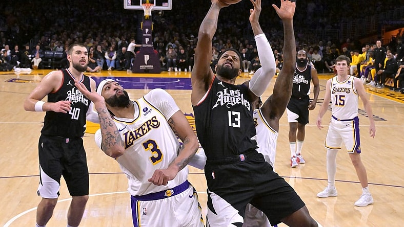 Jan 7, 2024; Los Angeles, California, USA;  Los Angeles Clippers forward Paul George (13) shoots over Los Angeles Lakers forward Anthony Davis (3) in the second half at Crypto.com Arena. Mandatory Credit: Jayne Kamin-Oncea-USA TODAY Sports