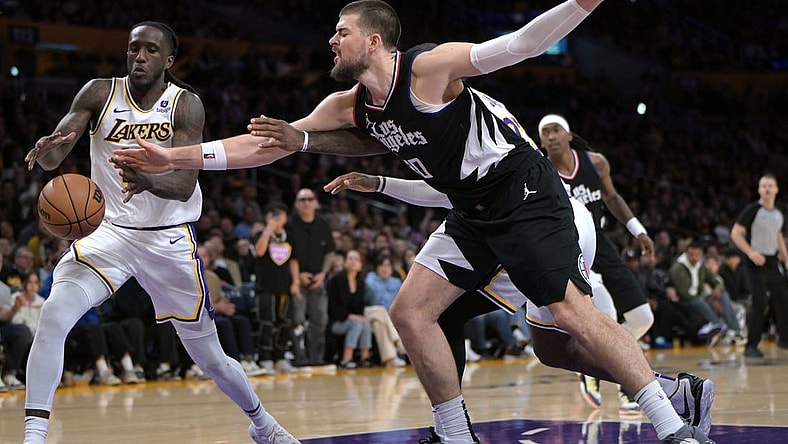 Jan 7, 2024; Los Angeles, California, USA;   Los Angeles Lakers forward Taurean Prince (12) and Los Angeles Clippers center Ivica Zubac (40) reach for a rebound in the second half at Crypto.com Arena. Mandatory Credit: Jayne Kamin-Oncea-USA TODAY Sports
