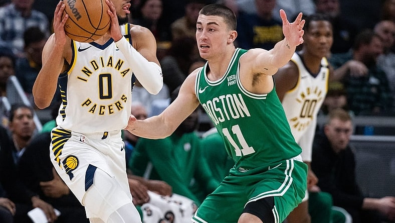 Jan 8, 2024; Indianapolis, Indiana, USA; Indiana Pacers guard Tyrese Haliburton (0) looks to pass the ball while Boston Celtics guard Payton Pritchard (11) defends in the first half at Gainbridge Fieldhouse. Mandatory Credit: Trevor Ruszkowski-USA TODAY Sports