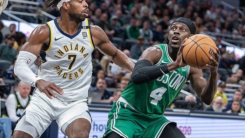 Jan 8, 2024; Indianapolis, Indiana, USA; Boston Celtics guard Jrue Holiday (4) shoots the ball while Indiana Pacers guard Buddy Hield (7) defends in the first half at Gainbridge Fieldhouse. Mandatory Credit: Trevor Ruszkowski-USA TODAY Sports