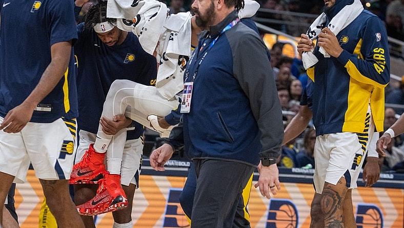 Jan 8, 2024; Indianapolis, Indiana, USA; Indiana Pacers guard Tyrese Haliburton (0) is carried off the court with apparent leg injury in the first half at Gainbridge Fieldhouse. Mandatory Credit: Trevor Ruszkowski-USA TODAY Sports