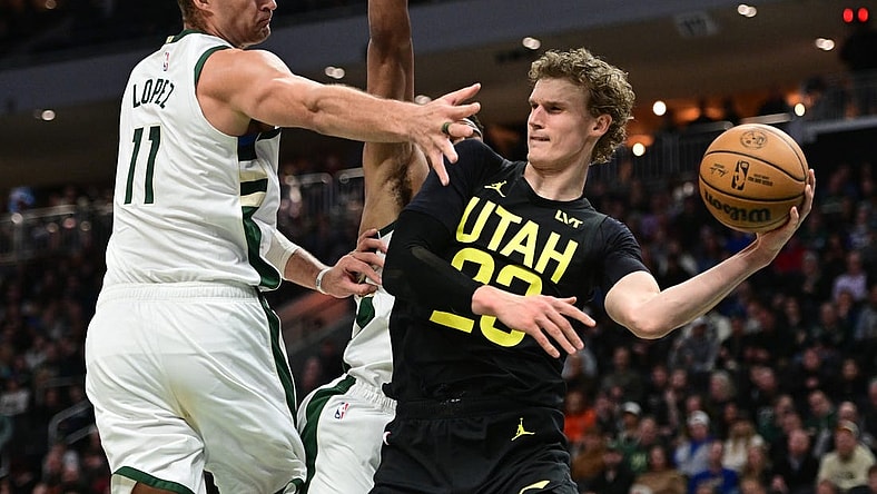 Jan 8, 2024; Milwaukee, Wisconsin, USA;  Utah Jazz forward Lauri Markkanen (23) looks to pass the ball away from Milwaukee Bucks center Brook Lopez (11) in the second quarter at Fiserv Forum. Mandatory Credit: Benny Sieu-USA TODAY Sports