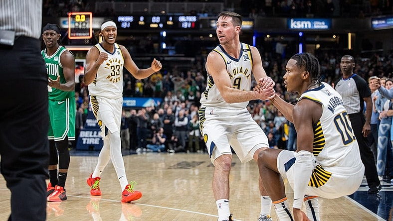 Jan 8, 2024; Indianapolis, Indiana, USA; Indiana Pacers guard T.J. McConnell (9) helps up Indiana Pacers guard Bennedict Mathurin (00) after a foul  in the second half against the Boston Celtics at Gainbridge Fieldhouse. Mandatory Credit: Trevor Ruszkowski-USA TODAY Sports