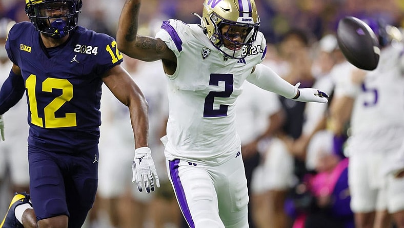 Jan 8, 2024; Houston, TX, USA; Michigan Wolverines defensive back Josh Wallace (12) and Washington Huskies wide receiver Ja'Lynn Polk (2) are unable to catch a pass during the third quarter in the 2024 College Football Playoff national championship game at NRG Stadium. Mandatory Credit: Thomas Shea-USA TODAY Sports