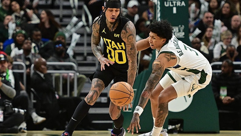 Jan 8, 2024; Milwaukee, Wisconsin, USA; Utah Jazz guard Jordan Clarkson (00) and Milwaukee Bucks guard MarJon Beauchamp (3) reach for a loose ball in the third quarter at Fiserv Forum. Mandatory Credit: Benny Sieu-USA TODAY Sports