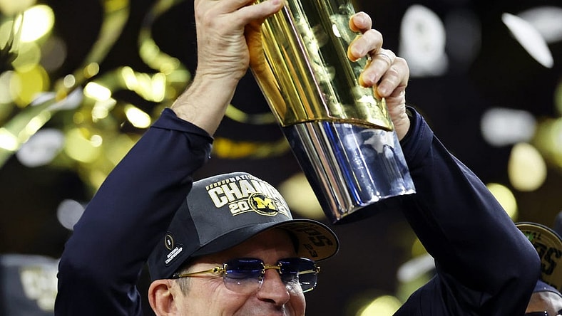 Jan 8, 2024; Houston, TX, USA; Michigan Wolverines head coach Jim Harbaugh holds the National Championship Trophy as he celebrates after winning 2024 College Football Playoff national championship game against the Washington Huskies at NRG Stadium. Mandatory Credit: Thomas Shea-USA TODAY Sports