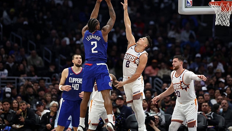 Jan 8, 2024; Los Angeles, California, USA;  Los Angeles Clippers forward Kawhi Leonard (2) shoots the ball over Phoenix Suns guard Grayson Allen (8) during the second half at Crypto.com Arena. Mandatory Credit: Kiyoshi Mio-USA TODAY Sports