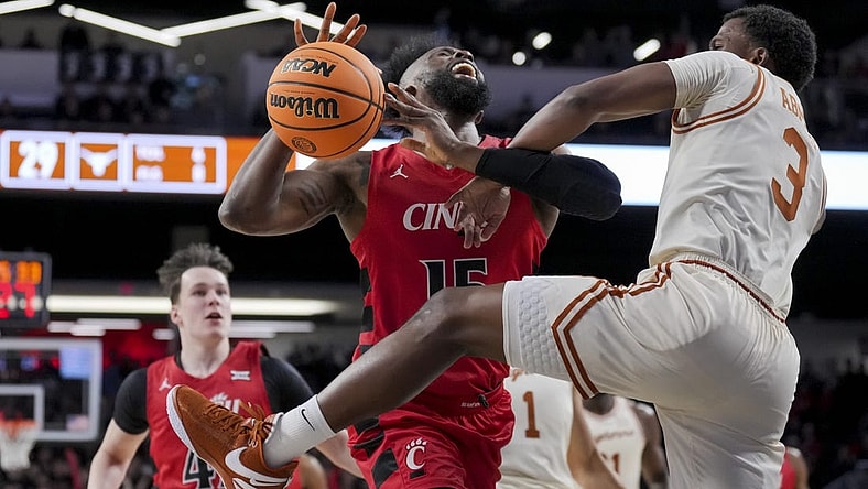 Jan 9, 2024; Cincinnati, Ohio, USA;  Cincinnati Bearcats forward John Newman III (15) reacts as he is fouled by Texas Longhorns guard Max Abmas (3) in the first half at Fifth Third Arena. Mandatory Credit: Aaron Doster-USA TODAY Sports