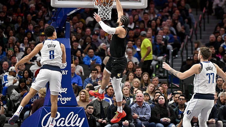 Jan 9, 2024; Dallas, Texas, USA; Memphis Grizzlies forward David Roddy (21) dunks the ball past Dallas Mavericks guard Josh Green (8) and guard Luka Doncic (77) during the second quarter at the American Airlines Center. Mandatory Credit: Jerome Miron-USA TODAY Sports