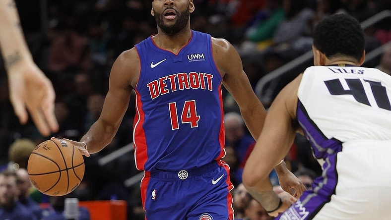 Jan 9, 2024; Detroit, Michigan, USA;  Detroit Pistons guard Alec Burks (14) dribbles defended by Sacramento Kings forward Trey Lyles (41) in the second half at Little Caesars Arena. Mandatory Credit: Rick Osentoski-USA TODAY Sports