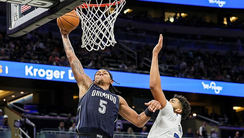 Jan 9, 2024; Orlando, Florida, USA; Orlando Magic forward Paolo Banchero (5) dunks against Minnesota Timberwolves center Karl-Anthony Towns (32) during the second half at KIA Center. Mandatory Credit: Mike Watters-USA TODAY Sports