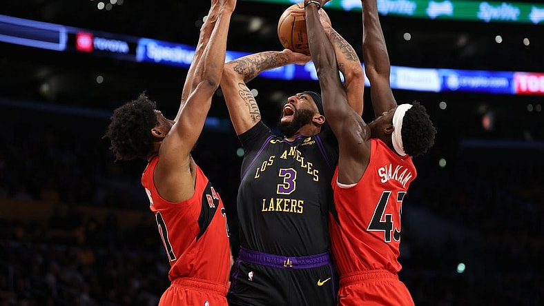 Jan 9, 2024; Los Angeles, California, USA; Los Angeles Lakers forward Anthony Davis (3) shoots the ball between Toronto Raptors forward Thaddeus Young (21) and forward Pascal Siakam (43) during the first quarter at Crypto.com Arena. Mandatory Credit: Kiyoshi Mio-USA TODAY Sports